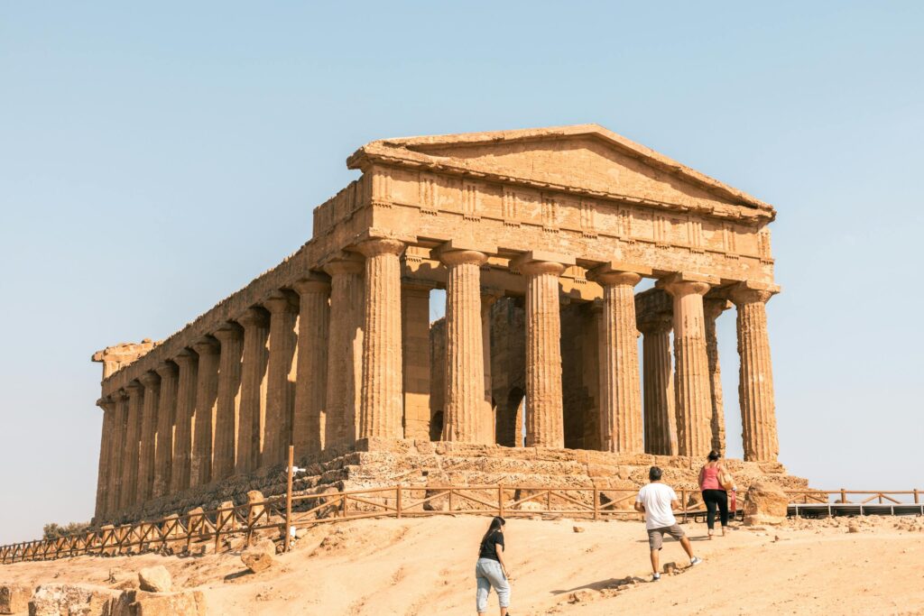 Explore the ancient sunlit Temple of Concordia in Agrigento, Italy, a stunning travel destination.