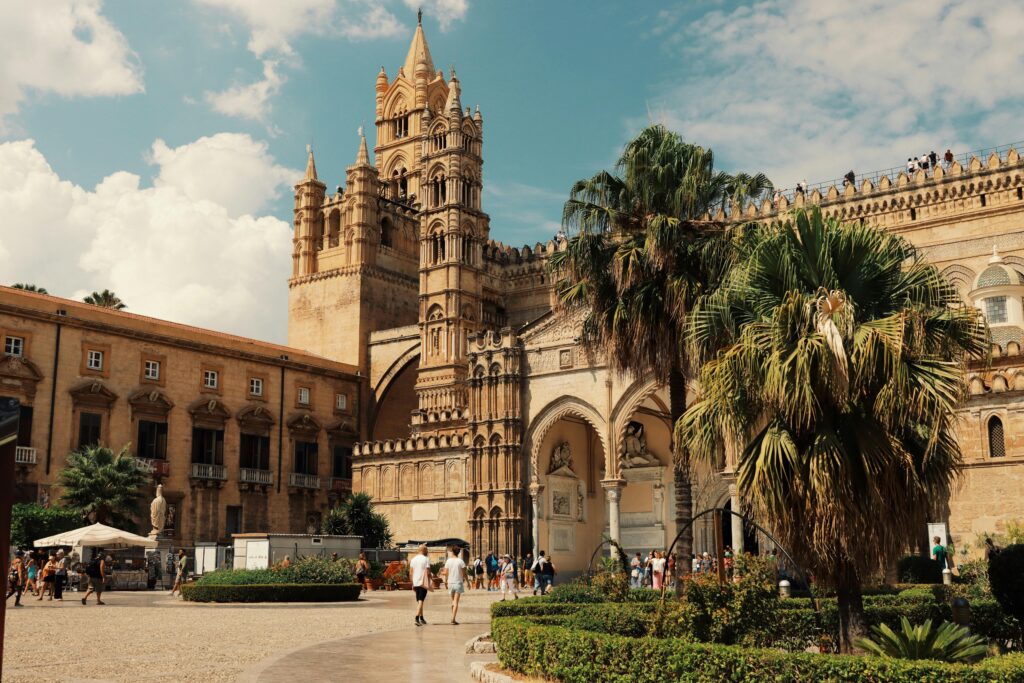 Explore the stunning architecture of Palermo Cathedral in Sicily, Italy, under a bright blue sky.